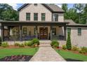 Close up of the home's charming front porch, featuring seasonal wreaths and a brick walkway at 313 Anderwood Rdg, Marietta, GA 30064