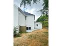 The home's backyard, with a small patio and lawn, offers a private outdoor space at 540 Langley Creek Dr, Loganville, GA 30052