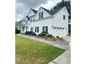 Charming two-story home featuring an attached garage and well-maintained lawn and landscaping at 540 Langley Creek Dr, Loganville, GA 30052