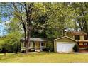 Beautifully landscaped home with a well-maintained front yard and an attached garage at 921 Hemingway Rd, Stone Mountain, GA 30088