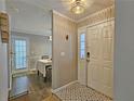 A welcoming entryway with tiled flooring, decorative light fixture, and view into the dining area at 1202 Countryside Pl, Smyrna, GA 30080