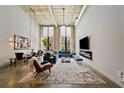 Bright, open living room featuring high ceilings, large windows, exposed brick, and modern stylish decor at 170 Boulevard Se # E120, Atlanta, GA 30312