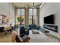 Bright living room with high ceilings, exposed brick, large windows, modern décor, and an open dining area at 170 Boulevard Se # E120, Atlanta, GA 30312