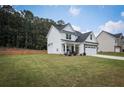 Charming two-story home featuring a well-manicured lawn, inviting front porch, and a two-car garage at 93 Oakdale Way, Temple, GA 30179