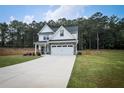 Charming two-story home featuring a well-manicured lawn, inviting front porch, and a two-car garage at 93 Oakdale Way, Temple, GA 30179