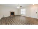Cozy living room featuring wood floors and a brick fireplace, perfect for relaxation at 4100 Summer Wood Dr, Snellville, GA 30039