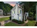 Well-manicured lawn highlights this charming home with blue shuttered windows and an attached garage at 800 Tradd Ct, Stone Mountain, GA 30087