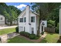 Well-manicured lawn highlights this charming home with blue shuttered windows and an attached garage at 800 Tradd Ct, Stone Mountain, GA 30087