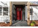 Close-up of a bright red front door with glass panels and natural wood columns at 1349 Lockhaven Sw Cir, Atlanta, GA 30311