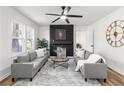 Bright living room with modern fireplace, ceiling fan, and gray sofas at 1349 Lockhaven Sw Cir, Atlanta, GA 30311