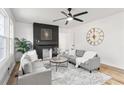 Bright living room with a modern fireplace, ceiling fan, and comfortable gray sofas at 1349 Lockhaven Sw Cir, Atlanta, GA 30311