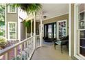 Charming front porch with wicker chair and welcome sign offers a cozy and inviting entrance to the home at 220 Mars Hill Rd, Powder Springs, GA 30127