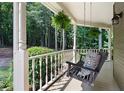 Relaxing porch swing with nature view provides a perfect spot to unwind outdoors at 220 Mars Hill Rd, Powder Springs, GA 30127