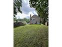 Expansive backyard featuring a well-maintained lawn and mature trees at 5030 N Bridges Dr, Alpharetta, GA 30022