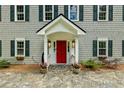 Inviting entrance with a red door, stone walkway, and well-maintained landscaping at 555 Valley Hall Dr, Atlanta, GA 30350