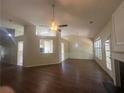 Open-concept living room features hardwood floors, ceiling fan, fireplace, and natural light at 76 Daisy Meadow Trl, Lawrenceville, GA 30044