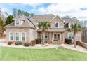 Charming brick home featuring a well-kept lawn and beautiful palm trees in the front yard at 1227 Castle Point Sw Ct, Conyers, GA 30094