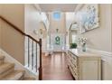 Elegant home foyer featuring hardwood floors, a staircase, and a decorative console table at 2629 Muskeg Sw Ct, Atlanta, GA 30331