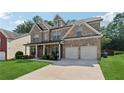 Charming two-story brick home with a well-manicured lawn and a two car garage at 2629 Muskeg Sw Ct, Atlanta, GA 30331