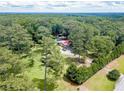 Aerial view of home showcasing lush greenery, pool area, and private, secluded setting at 7234 Post Rd, Winston, GA 30187