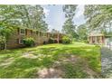 Spacious backyard featuring a well-maintained lawn, a deck, and a charming gazebo, perfect for outdoor relaxation at 7234 Post Rd, Winston, GA 30187