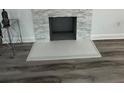 Close-up of a modern fireplace with gray stone surround and light gray hearth at 876 Pinehurst Sw Ter, Atlanta, GA 30310