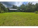 Charming home with a metal roof, green exterior, and a large grassy front yard at 1048 Seals Rd, Dallas, GA 30157
