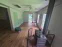 View of the living room with hardwood floors, a wood burning stove, and a ceiling fan at 1048 Seals Rd, Dallas, GA 30157