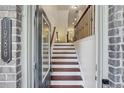 Welcoming entryway featuring hardwood floors, a staircase, and stylish decor at 1986 Cobblestone Ne Cir, Atlanta, GA 30319