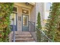 Inviting front entrance with a gray door, brick steps, and decorative plants at 1986 Cobblestone Ne Cir, Atlanta, GA 30319