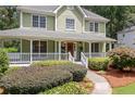 Charming home featuring a covered front porch and a meticulously maintained landscaped front yard at 526 Summer Ter, Woodstock, GA 30189