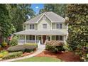 Charming two-story home with a welcoming front porch and beautifully landscaped front yard at 526 Summer Ter, Woodstock, GA 30189