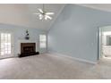Spacious living room with a fireplace, soft carpet, and abundant natural light at 571 Oak Vista Ct, Lawrenceville, GA 30044