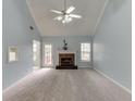 Bright living room with vaulted ceilings, fireplace, and neutral carpet at 571 Oak Vista Ct, Lawrenceville, GA 30044