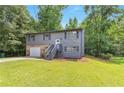 Charming two-story home with stone accents, landscaped front yard, and gray siding at 6906 Shangrila Way, Riverdale, GA 30296