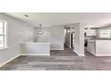 Spacious living room with stylish gray floors and light-filled windows at 6906 Shangrila Way, Riverdale, GA 30296