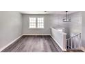 Bright room boasts new floors, light gray walls, and modern light fixture at 6906 Shangrila Way, Riverdale, GA 30296
