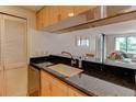 Kitchen featuring black countertops and open breakfast bar to living room, great for entertaining and everyday living at 3481 Lakeside Ne Dr # 902, Atlanta, GA 30326
