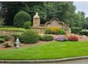 Westbrooke neighborhood stone sign with landscaped flower beds, manicured grass, and a fire hydrant at 3930 Regal Oaks Dr, Suwanee, GA 30024