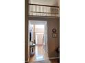 Bright foyer with hardwood floors, large arched window, stairs, and stylish console table at 3930 Regal Oaks Dr, Suwanee, GA 30024