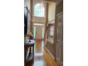 Grand foyer features hardwood floors, a staircase, and a large window letting in natural light at 3930 Regal Oaks Dr, Suwanee, GA 30024