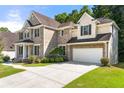 Brick home with attached garage, featuring a manicured lawn and inviting curb appeal at 733 Miller Run Run, Atlanta, GA 30349