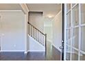 Inviting entryway featuring hardwood floors and staircase, creating a warm and welcoming ambiance at 1436 Weeping Tree Dr, Auburn, GA 30011