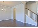 Open-concept living room boasting hardwood floors and neutral walls, seamlessly connected to other areas at 1436 Weeping Tree Dr, Auburn, GA 30011
