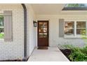 Close up showcasing the beautiful stained wood front door with glass panels and gray shutters at 3581 Ridge Se Rd, Smyrna, GA 30080