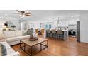 Bright and spacious open-concept living area with hardwood floors flowing into the kitchen and dining space at 3581 Ridge Se Rd, Smyrna, GA 30080