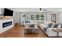 Comfortable living room with large windows, modern fireplace, and stylish furnishings at 3581 Ridge Se Rd, Smyrna, GA 30080