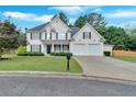 Traditional two-story home with a manicured lawn, a two-car garage, and complementary landscaping at 3957 Marquette Nw Way, Kennesaw, GA 30144
