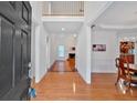 Spacious foyer with hardwood floors, showcasing a view into the living room and dining area at 3957 Marquette Nw Way, Kennesaw, GA 30144