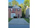 Charming two-story brick home with a well maintained front lawn and driveway on a sunny day at 5570 Hampton Ct, Atlanta, GA 30349